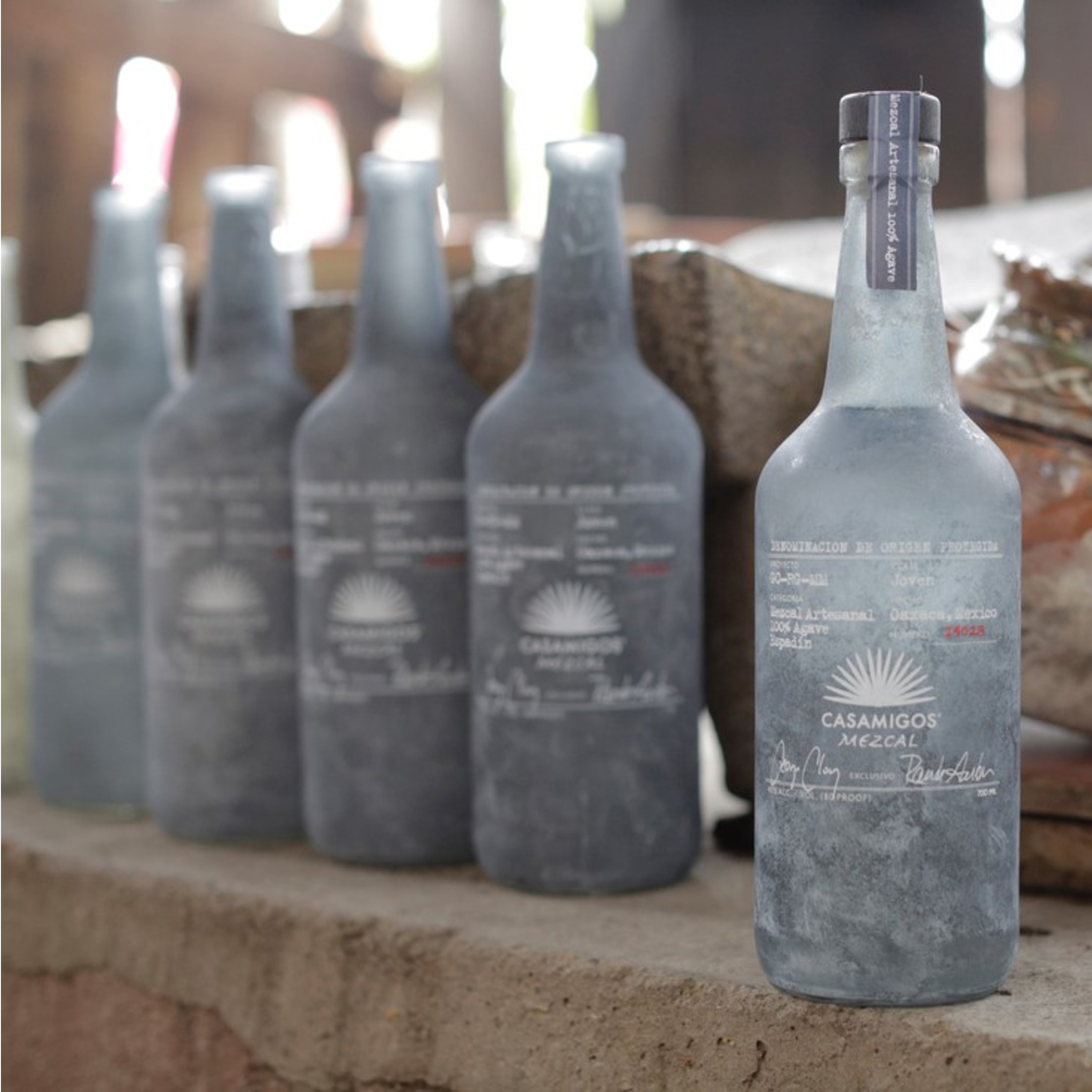 bottles of casamigos mezcal lined up on a table